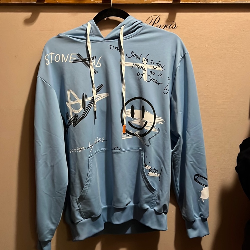 Blue hoodie with writing and designs